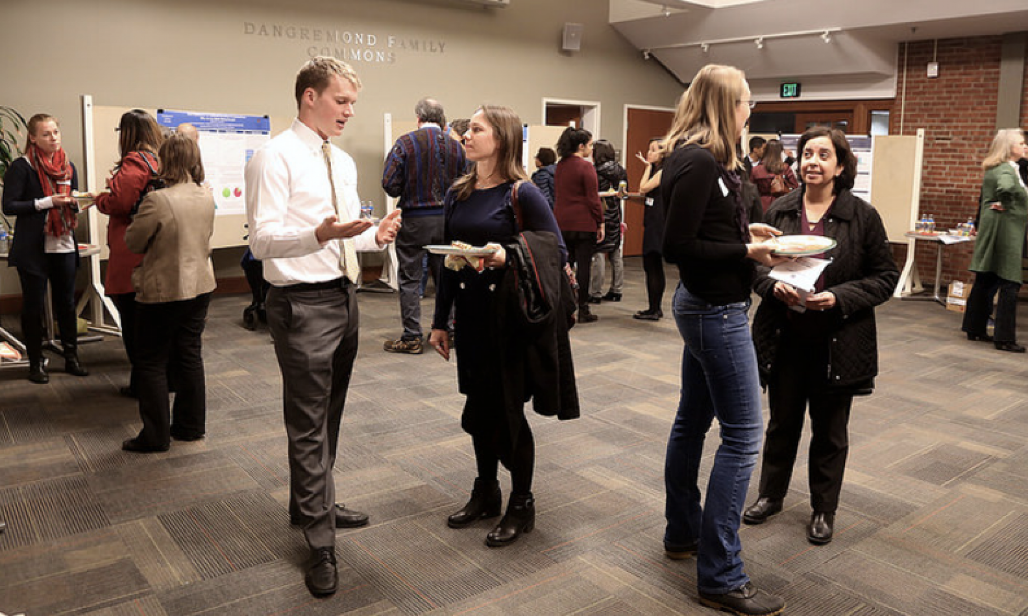 Students and Faculty converse during a research poster session