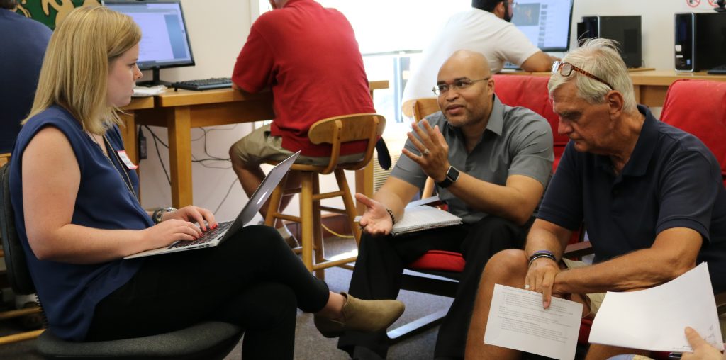 Megan Hartline, Associate Director of Community Learning, listens to feedback from Hartford community partners Emmanuel Adero and Frank Hagaman.