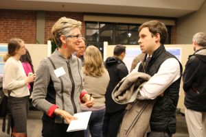 Professor Carol Clark and David Lavery, Connecticut Fair Housing, chat at the Dec. 2017 Research Fellows presentations. 