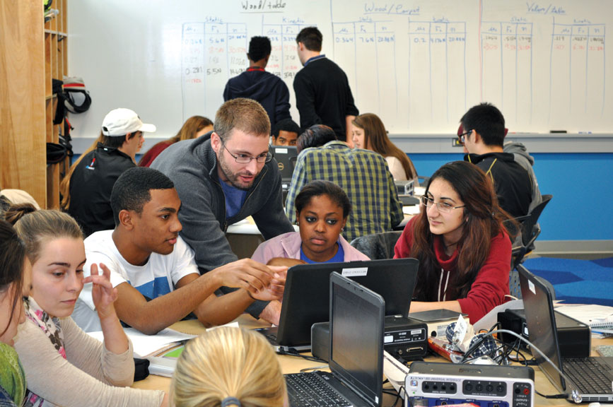 Assistant Professor of Physics Brett Barwick works with students in Physics 141. 