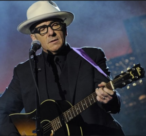 COURTESY OF itunes.apple.com. Elvis Costello performs. 