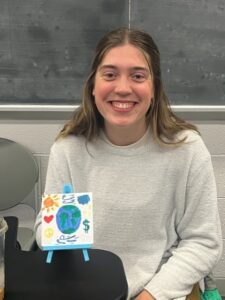 Students with their artwork