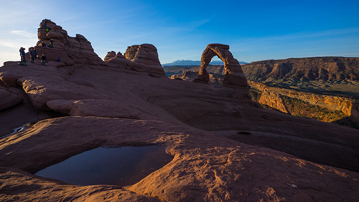 Delicate Arch at sunrise. Yep, that little figure in neon green, close to the highest spire is Adam.