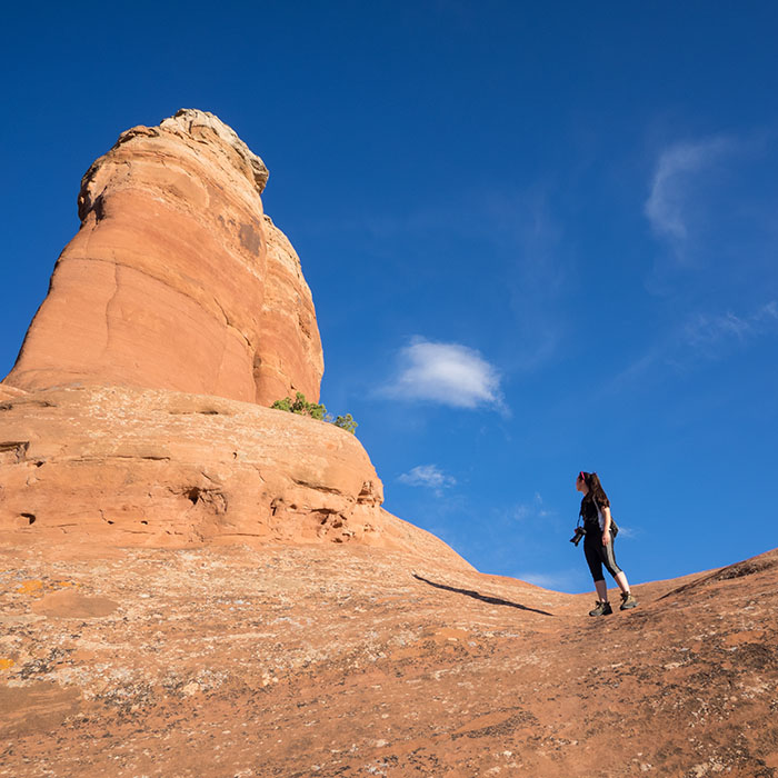 Cassia sizing up the red rock - Arches National Park, 2015