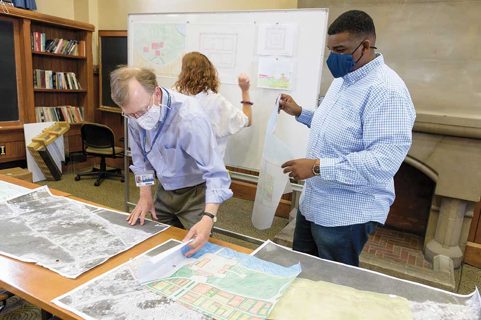 David Duncan '79 and Jordan Lewis '22 looking at maps