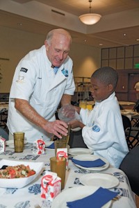 Raether and a Dream Camper share the duties of table captain during a fine dining/healthy eating event in 2011.