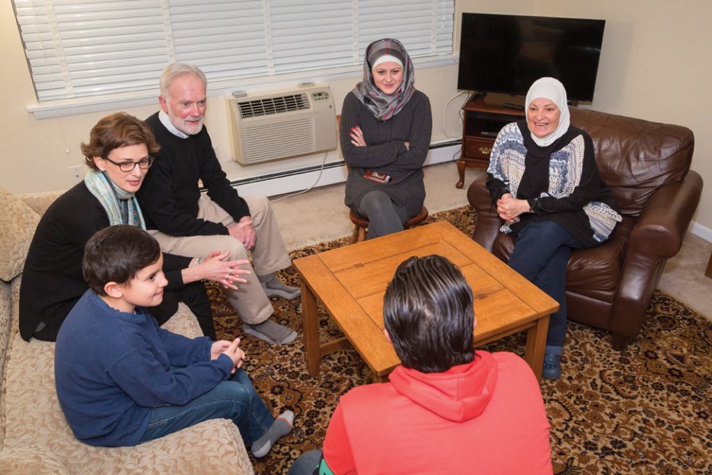 Trinity College Chaplain Allison Read, Drew Smith ’65, and Maryam Bitar IDP’16 talk with the Syrian family that came to the United States under the co-sponsorship of the College and Hartford’s Trinity Episcopal Church communities.