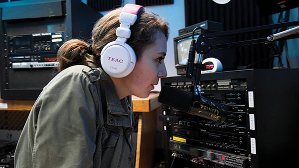 student at the microphone at the radio station